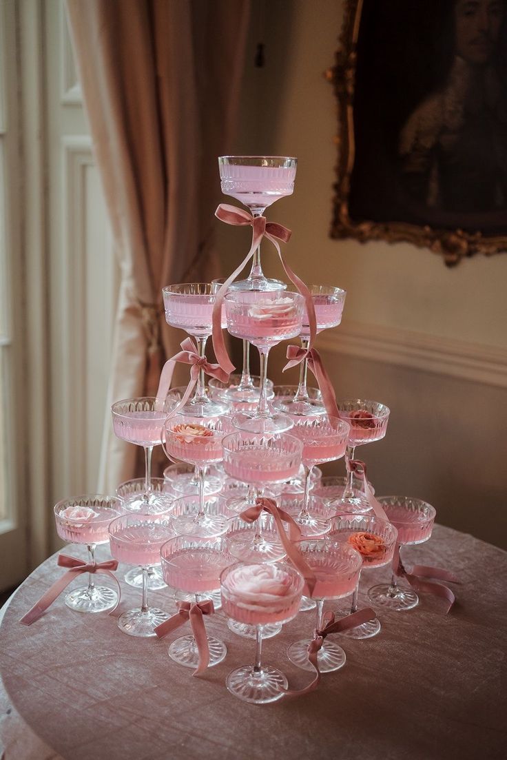 Blush silk ribbon-wrapped cake on a pedestal
